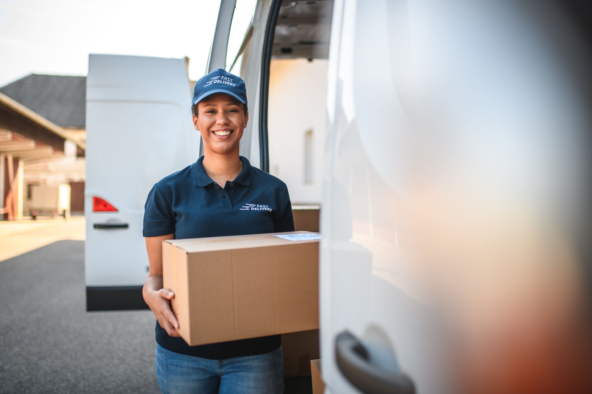 Young Delivery Woman Carrying A Package