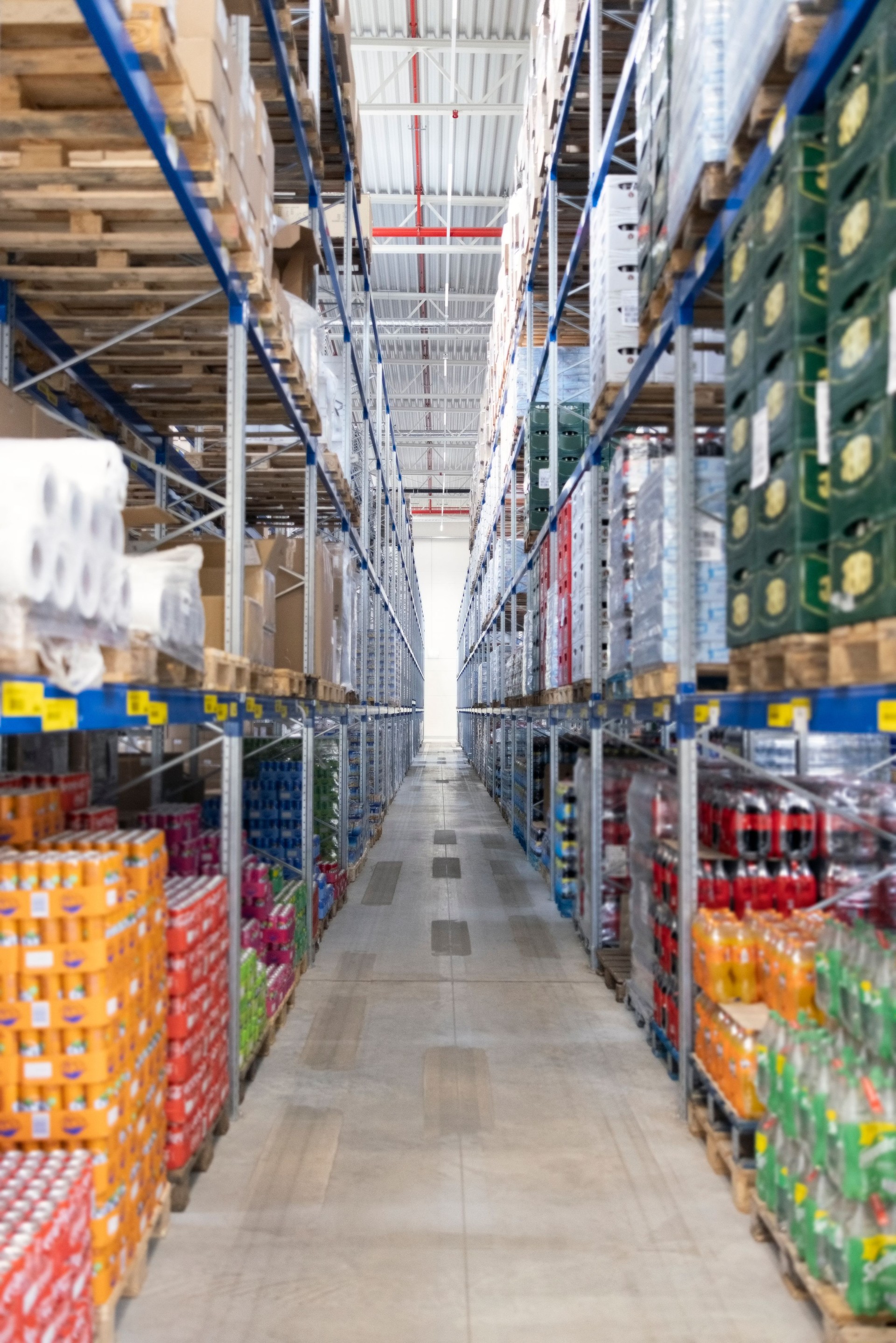 Warehouse shelves with boxes and soft drink products